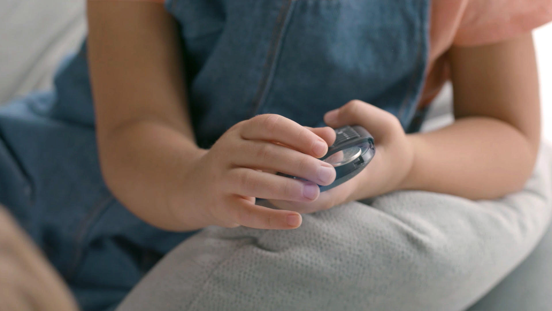 Child discovering a lithium coin battery